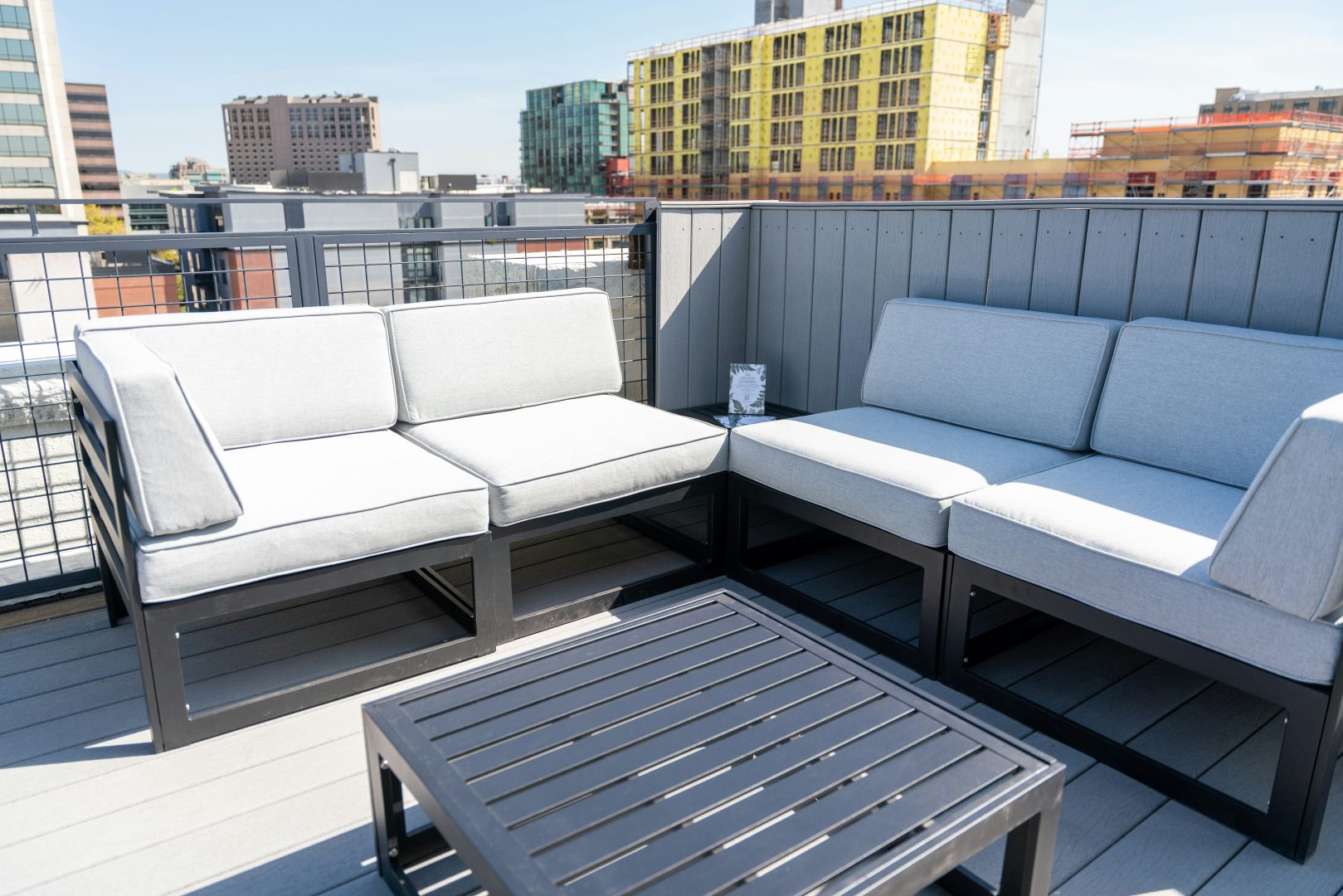 Rooftop patio furniture offers a relaxing city view.